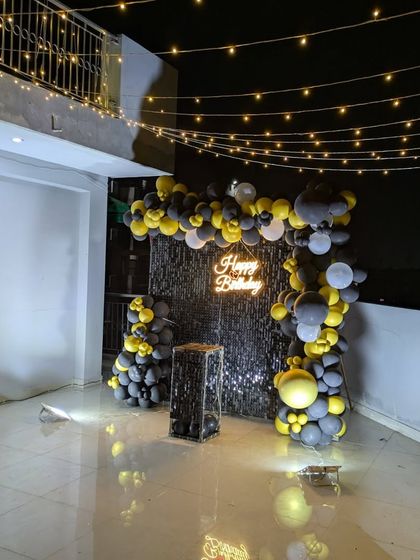 The entire terrace setup, showing the sequin wall backdrop complemented by a canopy of string lights for a magical atmosphere.