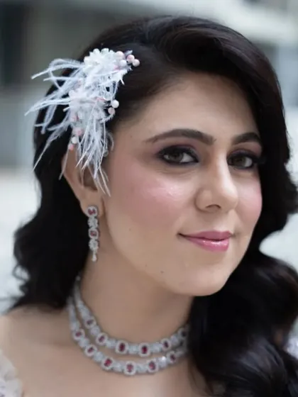 For this glamorous look, I styled the hair in classic Hollywood waves and added a feathered accessory. This is a great option for a cocktail party or a themed event where you want to make a statement.