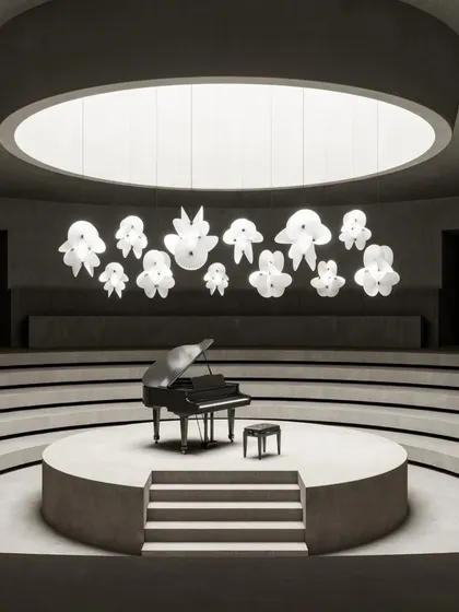 The new, grander scale of the Serpentine Light by Front for Moooi, seen here in a dramatic concert hall setting. The fixture's paper-like forms create an illusion of airy elegance.