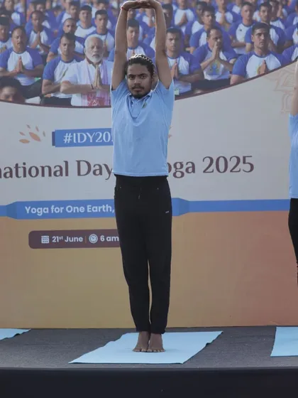 Demonstrating Urdhva Hastasana (upward salute), a simple yet effective stretch to lengthen the spine.