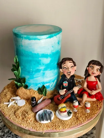 The full view of the beach story cake, showing how all the personalized elements and figurines come together.