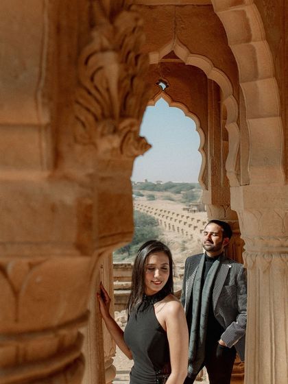 A beautifully composed shot looking through an archway at a Jaisalmer heritage site. I love using architectural elements to frame couples, adding depth and a sense of place to their pre-wedding photos.