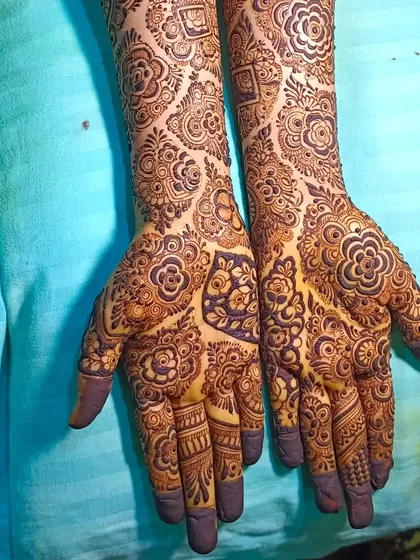 A beautiful, clean shot of a full bridal mehendi, showing the symmetry and intricacy of the design.