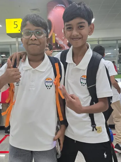 Two of our young players looking sharp in their academy polos at the airport.