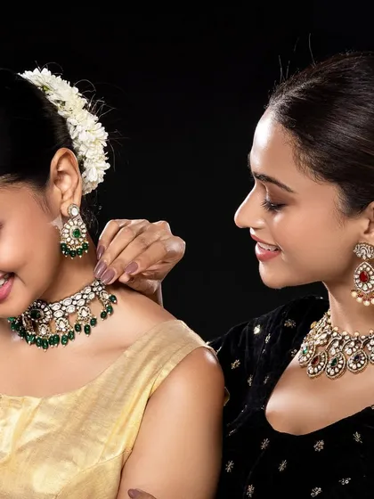 Two models are featured in this shot, showcasing complementary sets of traditional jewellery. This type of image is effective for campaigns highlighting collection diversity or "best friend" gifting ideas.