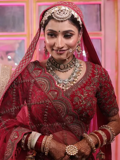 A beautiful candid shot of my bride Varsha. Her makeup features soft, glowing skin and defined eyes, perfectly complementing her traditional red bridal attire and oxidized silver jewelry.