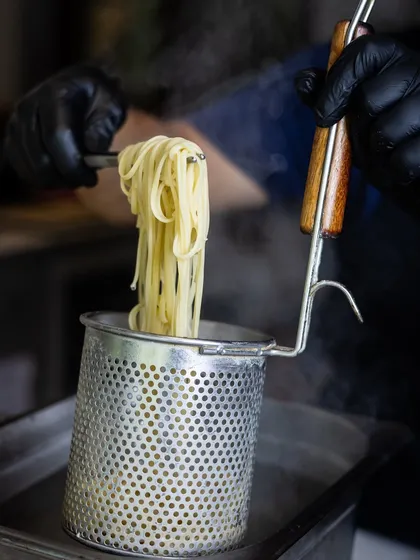 The steam rising from freshly cooked pasta is a promise of the delicious meal to come. This is where it all begins, before the pasta is tossed in one of my signature sauces.