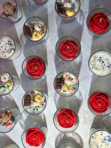 Bulk orders brightened so many celebrations this year. This image shows a variety of shot glass candles, including rose, teddy, and chocolate themes, ready for a large order.