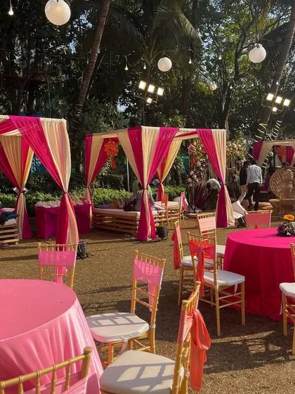 A charming Mehendi setup with pink and cream cabanas and matching table decor. This creates cozy and stylish seating areas for guests to relax and mingle.