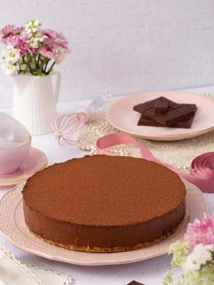 My whole Belgian Chocolate Mousse Cake, dusted with cocoa powder and ready to be the star of your dessert table.