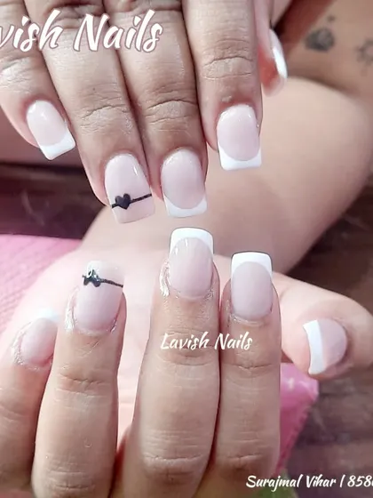 A simple and sweet French manicure with a tiny hand-drawn heart on the ring finger.