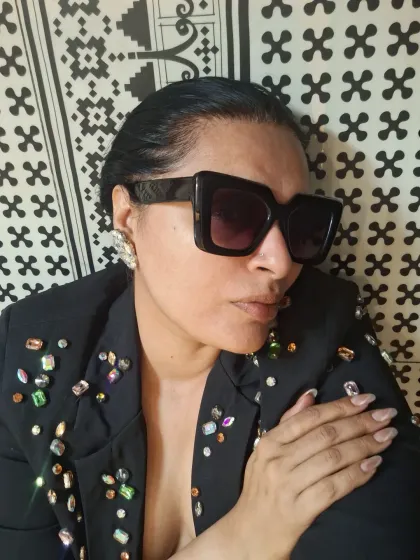 All about the attitude. A close-up shot featuring a jeweled blazer and bold sunglasses, showing that sometimes the details are the entire story.