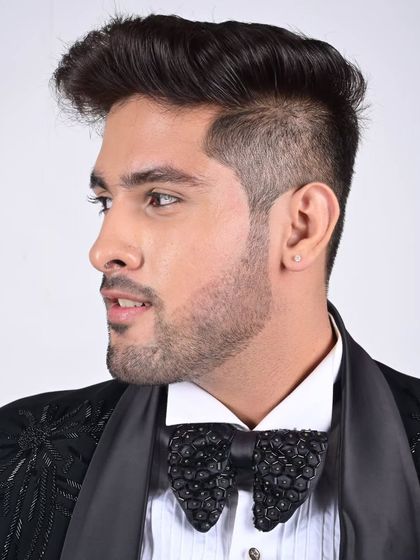 A close-up of our custom-designed textured bow tie, paired with a classic tuxedo shirt and jacket. It's the small details that complete the look.