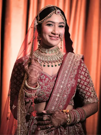 A happy, smiling portrait of the bride. Her makeup is designed to enhance her joy, with a radiant finish and defined eyes that sparkle.