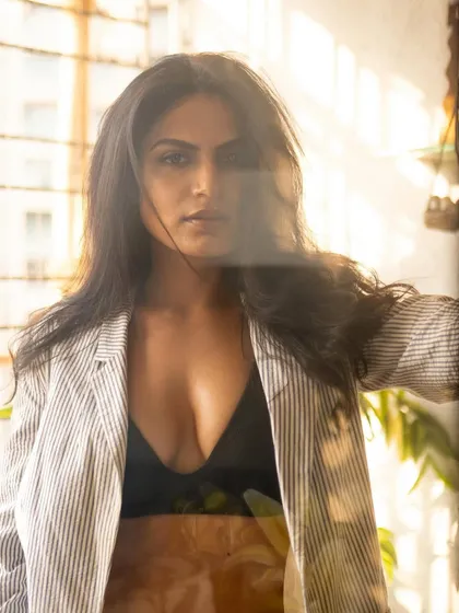 A direct-to-camera look from the same window session. The flare and reflections on the glass add an artistic, layered effect.