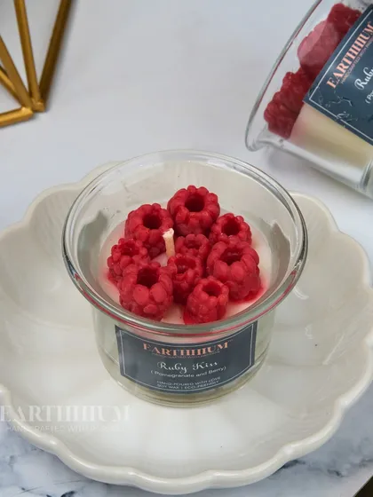 The Ruby Kiss candle is filled with juicy wax raspberries for a burst of color and fruity fragrance.