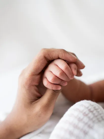 A mother's hand holding her baby's. A simple, timeless, and incredibly meaningful photograph.