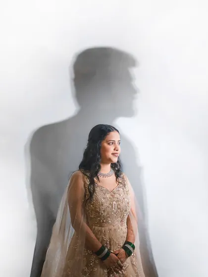 I love playing with light and shadow to create unique, artistic portraits. This creative shot of Riya, with Omkar's silhouette, adds a touch of drama and artistry to their engagement gallery.