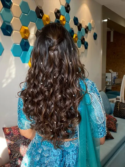 A back view of Mansi's gorgeous hairstyle. The soft curls are dotted with pearls, creating a dreamy and elegant look.