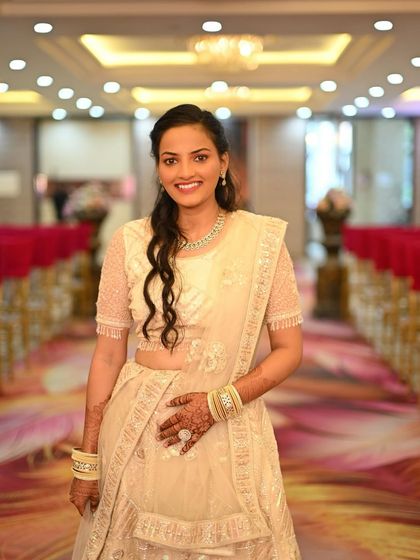 The perfect smile from a happy client. This ivory lehenga with matching jewellery creates a sophisticated and graceful look for any wedding function.