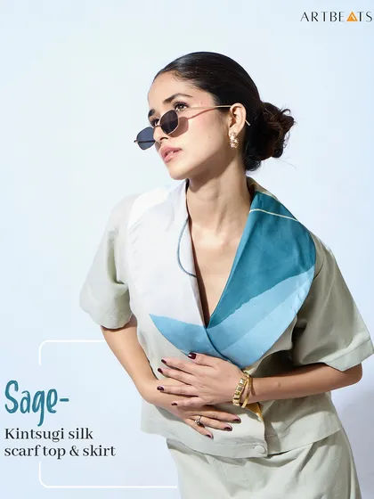The Sage Kintsugi silk scarf top and skirt. This elegant co-ord set from the collection features a beautiful, art-detailed collar that drapes like a scarf, embodying the beauty of imperfection.