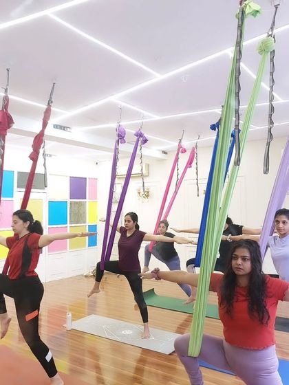 A beautiful shot of the class in a synchronized warrior variation. This shows the unity and shared energy of our group sessions.