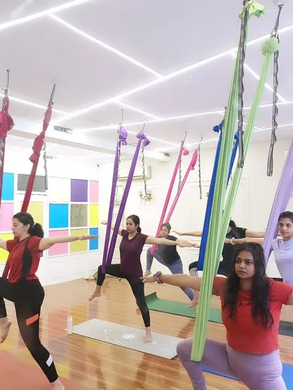 A beautiful shot of the class in a synchronized warrior variation. This shows the unity and shared energy of our group sessions.