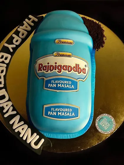 A fun and quirky cake designed to look exactly like a tin of Rajnigandha pan masala. It’s a perfect example of a personalized, realistic cake that brings a smile to everyone's face.