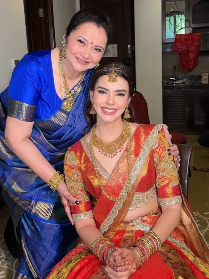 A heartwarming photo of the bride with her mother. Both look beautiful, showcasing our ability to create age-appropriate and elegant traditional looks.