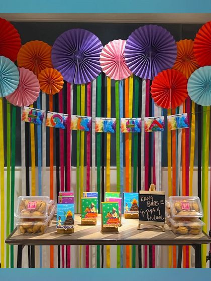 Bursting with color, just like Holi! This vibrant backdrop made of colorful paper fans and streamers is a simple yet highly effective way to decorate for the festival of colors.