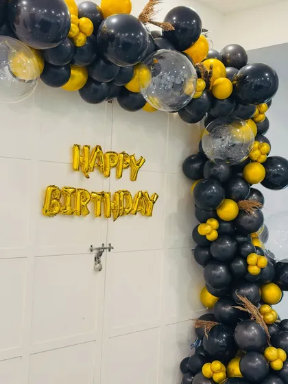 Another angle of the stylish black, gold, and confetti balloon arch. I use high-quality balloons and creative arrangements to make any entrance feel grand.