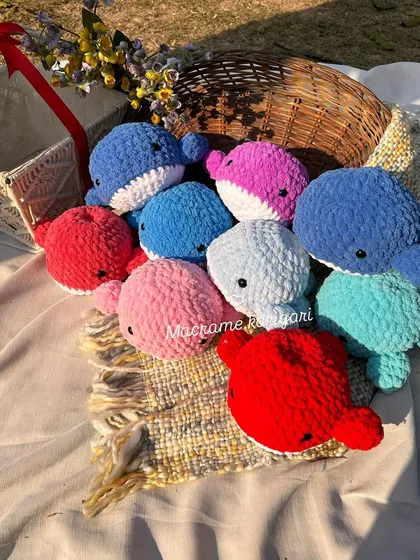 Our family of colorful crochet whales, made from plush chunky yarn. These are great for imaginative play or as cute decor for a child's room.