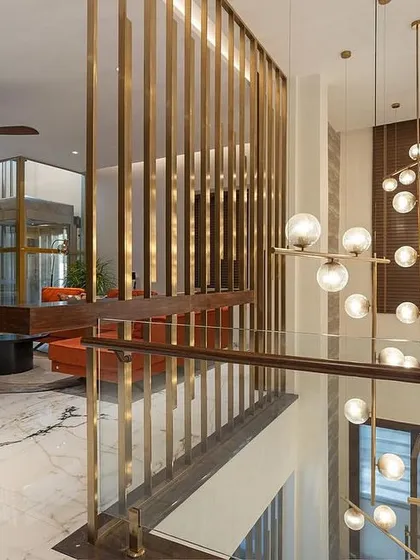A view from the upper level, looking down at the family lounge and the stunning multi-level chandelier. Our furniture helps define this grand, open space.
