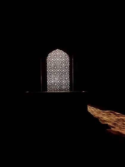 An intricate marble jali, or latticed screen, inside Humayun's Tomb. These screens allowed for ventilation while creating beautiful patterns of light and shadow, a hallmark of Mughal design.