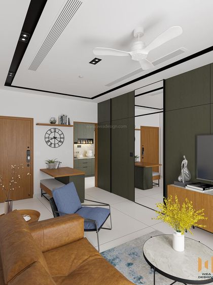 A view from the sofa, showing the foldable dining table and the concealed pivot door to the bedroom.