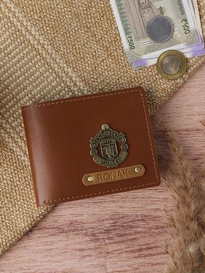 This personalized men's wallet in tan vegan leather features a Manchester United charm, making it a great custom gift for a football fan.