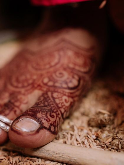 Even the toes have a beautiful, dark stain. This close-up shows the intricate details of the foot mehendi after the paste has been removed.