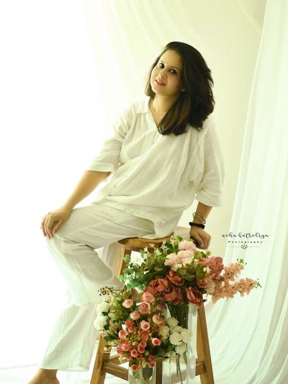 A moment of self-love. This simple, light-filled self-portrait in a comfortable white outfit captures a feeling of peace and contentment.