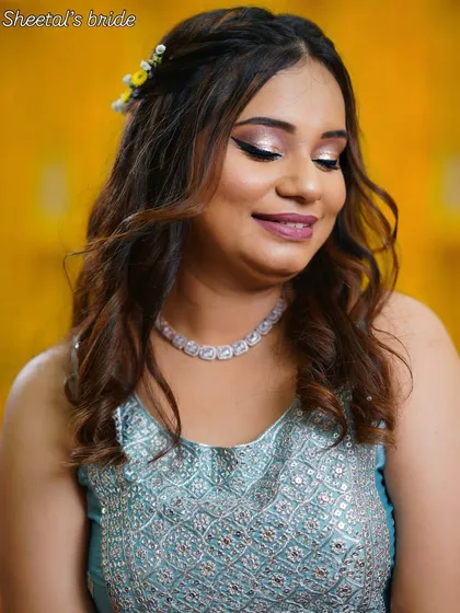 A lovely portrait of my Haldi bride Urvisha, with soft, shimmering makeup that catches the light beautifully.