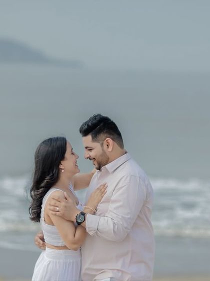 A joyful and natural moment of a couple sharing a laugh by the sea. Capturing these unposed interactions is key to my photography style.
