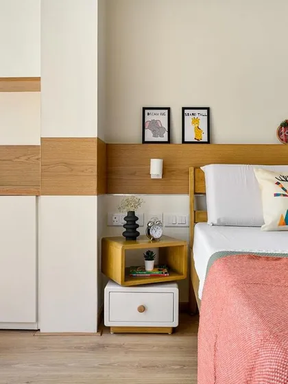 In this 10x10 room, we extended the balcony to create an exclusive study space. The room features wooden flooring and paneling, a custom bed, and a unique bedside table with a rotatable top shelf.