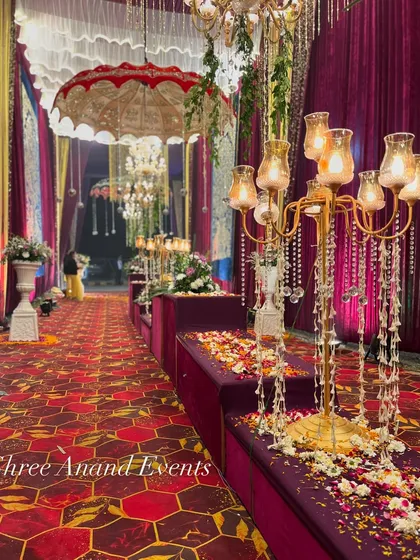 A close-up of the detailed walkway decor, with crystal candelabras, flower petals, and traditional umbrellas creating a rich, layered look.