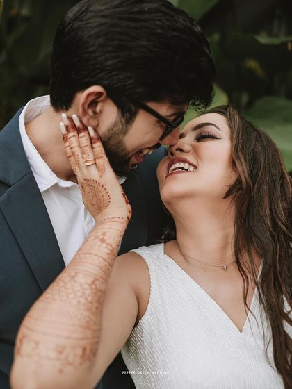 The joy on Akshatha's face as Jeethesh pulls her close. Her henna-adorned hand adds a beautiful traditional detail to this modern, romantic moment.