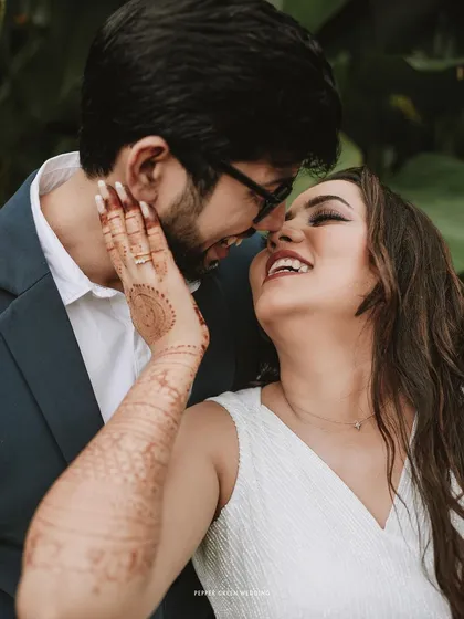 A beautiful close-up capturing the bride's hand on her groom's face, a tender and intimate moment full of emotion.