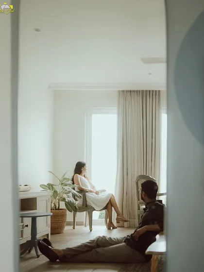 An artistic shot using a mirror's reflection to frame the couple in their studio setting, creating a sense of depth and perspective.