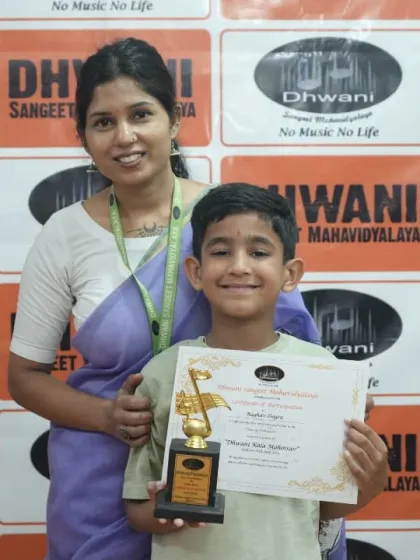 A teacher and student pose together, celebrating her win at the annual art event.