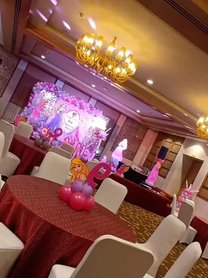 An overview of a grand Barbie-themed birthday party in a banquet hall. We handle everything from the stage backdrop and table centerpieces to the overall hall decoration to create a cohesive and magical world.