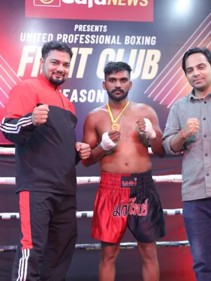 A boxer with his team after a successful bout. We build a strong support system around our fighters.