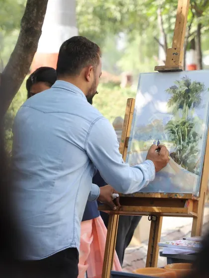 Adding details to the trees in the landscape painting. This stage brings the composition to life.