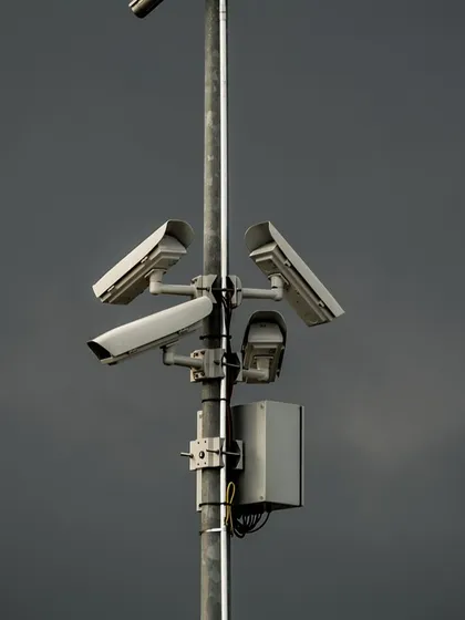 A pole-mounted camera setup against a dark sky, showing its readiness to protect your property in any weather.